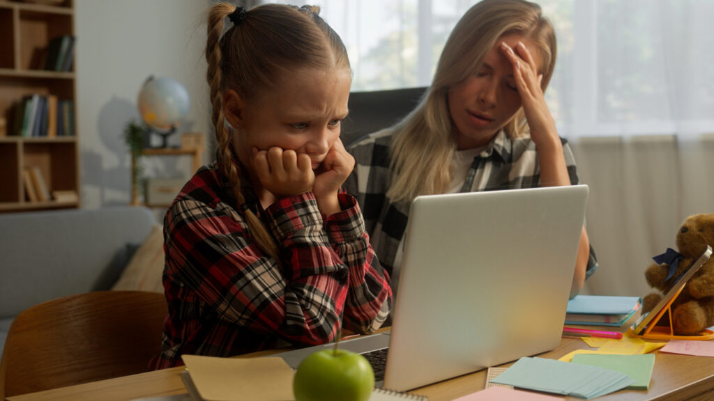 Stressed upset Caucasian mother woman female mom parent headache girl schoolgirl learner studying online laptop at home little pupil child e-learning difficulty daughter kid educational problem family. High quality 4k footage